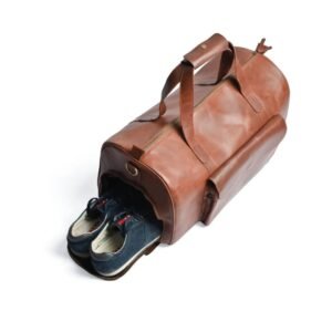 Premium tan genuine leather weekender duffle bag with a dedicated zipped shoe compartment on a white background.
